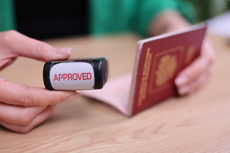 Passport checks bring joy as approval stamp seals the travel dream during a sunny afternoon in a...