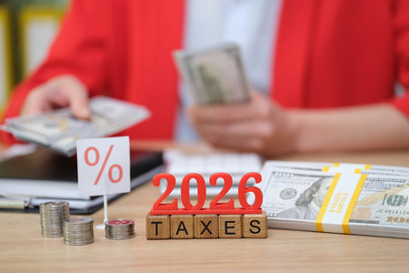 Counting bills and planning ahead for taxes in 2026 during a busy financial review session