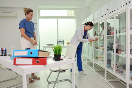 Busy healthcare professionals organize supplies in a modern clinic setting during a weekday afternoonの写真素材