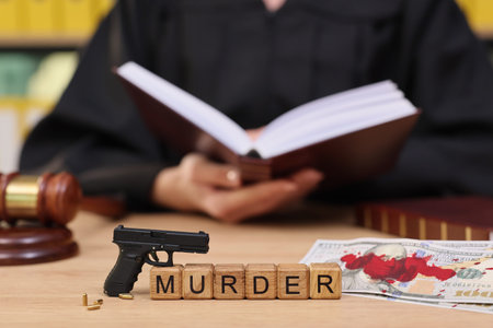 Dramatic courtroom scene with a judge reading while gun and murder blocks lie on the table
