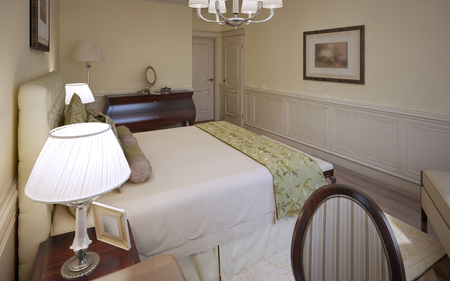 Traditional design of english bedroom. Luxury bedroom with beige walls, medium tone hardwood floors, a soft done bed with TRS tufted headboard bed and a mahogany furniture. 3D renderの写真素材