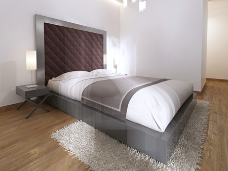 Luxurious one double bed in the hotel room in art Deco. A large padded headboard and bedside tables with table lamps. 3D render.の写真素材