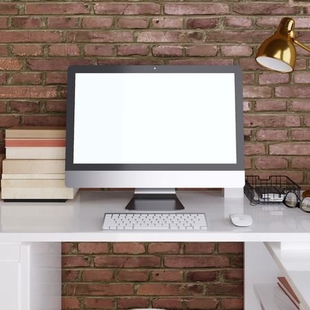 mockup monitor on white desktop background on a red brick wall. 3D render.の写真素材