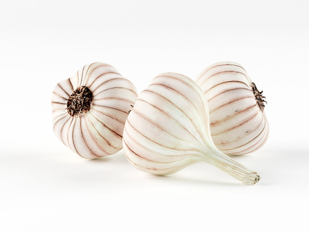 Three heads of garlic isolated on white background. 3d render.の写真素材