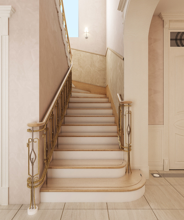 Staircase in the interior of a private house in a classic design. Wooden steps with gilded forged rails.の写真素材