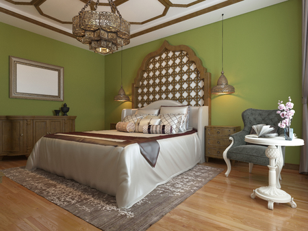 Oriental bedroom in Arab style, with a wooden headboard and green walls. TV unit, dressing table, armchair with coffee table. 3D rendering.の写真素材