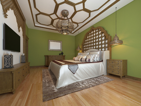 Oriental bedroom in Arab style, with a wooden headboard and green walls. TV unit, dressing table, armchair with coffee table. 3D rendering.の写真素材