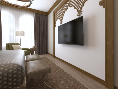 A TV on the wall and a TV stand, wooden carvings framed in Middle Eastern Arabic style. 3D rendering.の写真素材