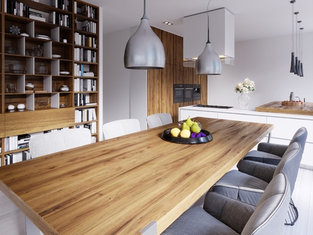 dining area with a modern designer table with six chairs in a loft style. Large built-in shelves for books, kitchen and living area. 3d renderingの写真素材