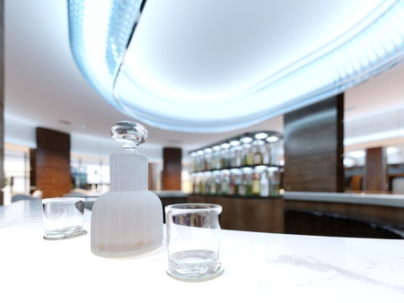 A decanter with alcohol and two glasses on a white marble countertop. 3d rendering.の写真素材