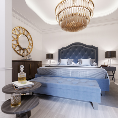 A luxurious bedroom in a classic style with gold elements and a blue bed cloth and a wooden dresser and dressing table. 3d rendering.の写真素材