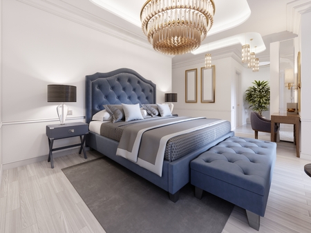 The design of a luxurious bedroom in a contemporary style with a blue bed and white walls. Armchair with footrest and dressing table with mirror. 3d rendering.の写真素材