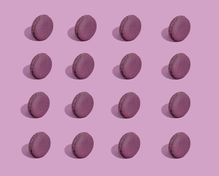 Colorful french macarons cookies. French pastry on a pink background, minimal concept. Lots of macaroons, hard light, hard shadows.の写真素材