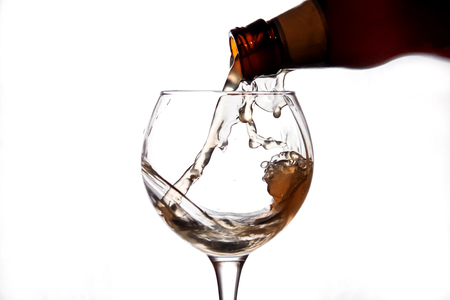 the liquid is poured into a glass and sprayの写真素材