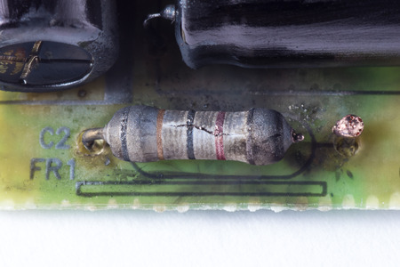 Part of the destroyed circuit board with focus on exploded resistorの写真素材