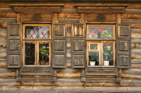 Russian traditional decorative casing of windows with open shutters.  The photograph was taken in Suzdal, Russiaの写真素材