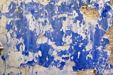Texture of old dirty wall covered with Ñracked plaster and painted with blue paintの写真素材