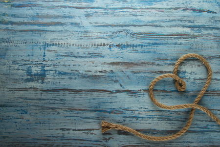 rope heart on a wooden backgroundの写真素材