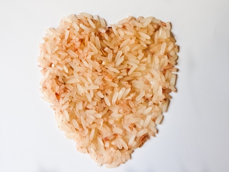 heart shape brown rice isolated on white background の写真素材