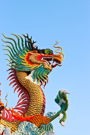 Golden dragon statue and blue skyの写真素材