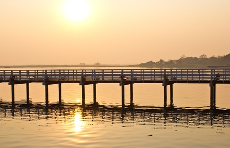 Wooden bridge in the marsh at sunsetの写真素材