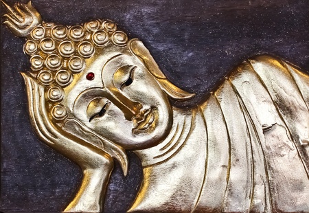 The golden Buddha on a wood floorの写真素材
