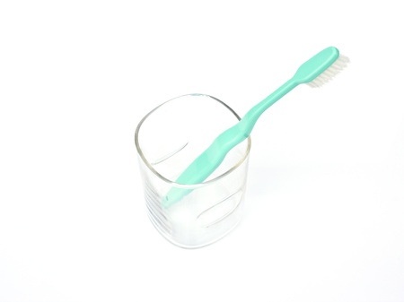 Green tooth brush in glass  Isolated on white background の写真素材