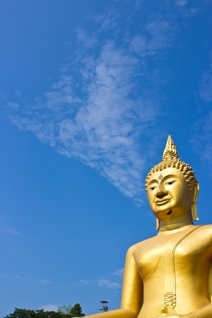Golden Statue of Buddha in Thailand and blue skyの写真素材