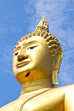 Close up Golden Statue of Buddha in Thailand and blue skyの写真素材