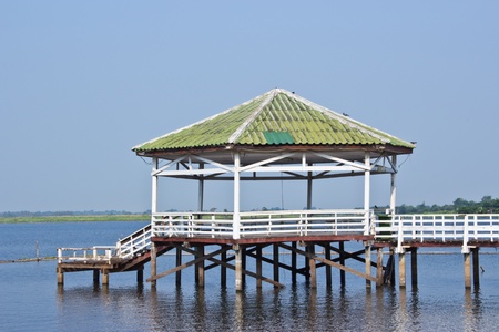 Wood bridge and wooden gazebo in the pool and blue skyの写真素材