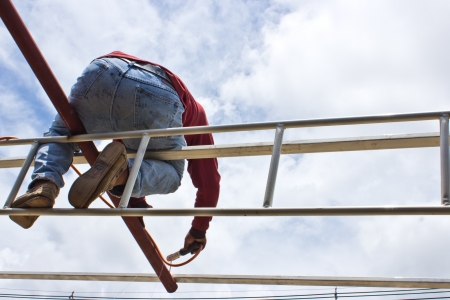 a roofer on a roof putting down shinglesの写真素材