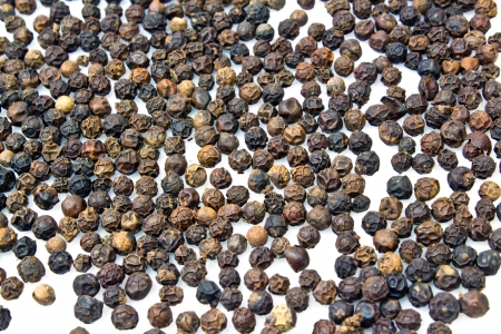Close-up of peppercorns on white background 