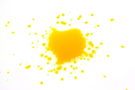 Yellow ink drops on a white background の写真素材