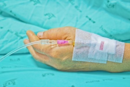 Close up of a woman patient in hospital with saline intravenous (iv)の写真素材