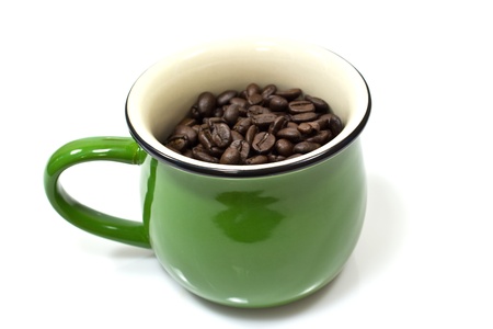 A green cup and coffee beans on white backgroundの写真素材