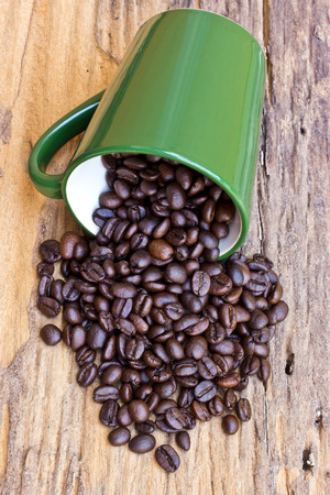 A Cup of coffee beans is on wooden boardの写真素材
