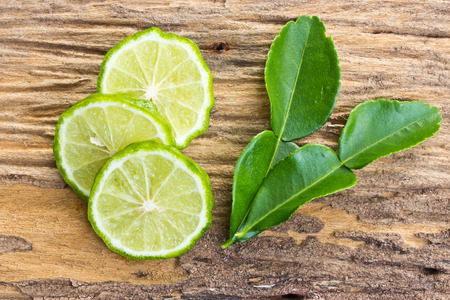 kaffir limes on old woodの写真素材
