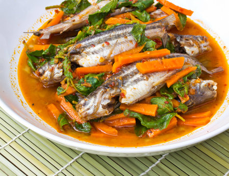 Fish Curry in white dish on bamboo brown strawの写真素材