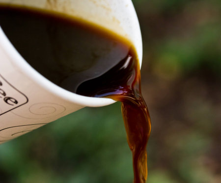 Pouring coffee out of paper cups.の写真素材