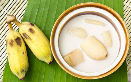 Banana in coconut milk and banana on banana leaves,Thai desertの写真素材