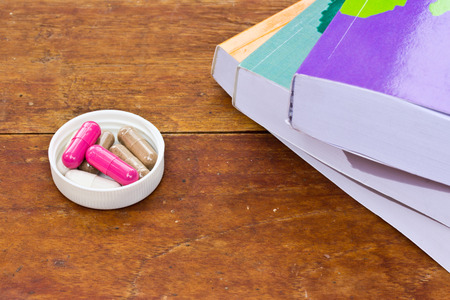 Tablets and a pile of books on the table.の写真素材