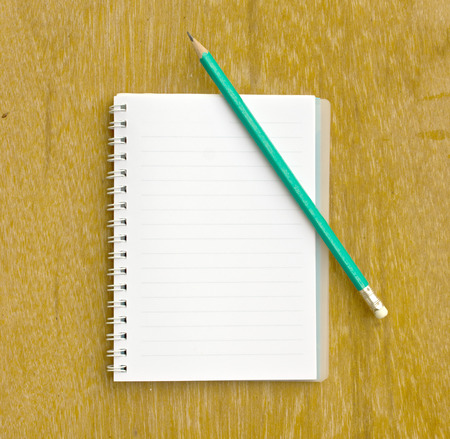 note and pencil on wooden board