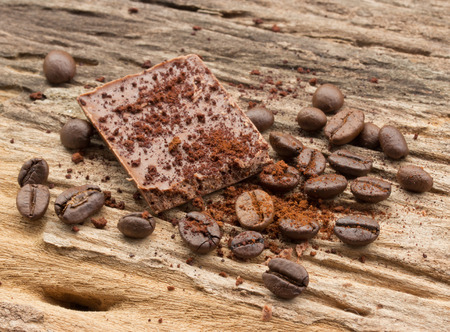 Chopped chocolate and coffee bean with cocoa on wood backgroundの写真素材