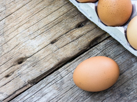 chicken egg on wood and chicken egg in panel eggs on woodの写真素材