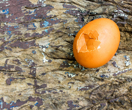 Break eggs on a wood backgroundの写真素材