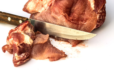 sliced raw meat and knife on whiteの写真素材