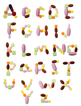 many pills alphabet on white backgroundの写真素材