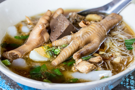 Asian delicatessen - chicken foot in noodle soupの写真素材