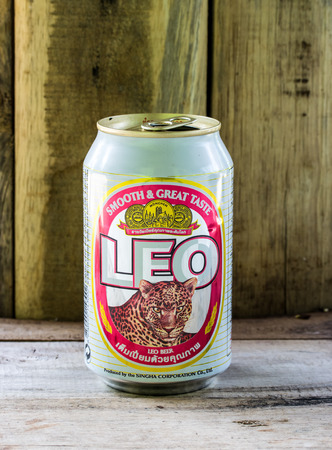 BANGKOK - APRIL 5, 2015: Can of Leo beer on wood background . Leo beer created by boon rawd brewery co.,ltd in Thailandのeditorial素材