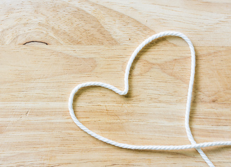Heart Rope on a Wooden backgroundの写真素材